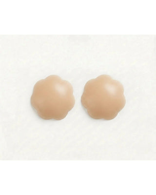 Two beige silicone pasties on a white background